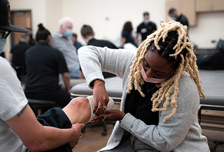 Student assisting patient